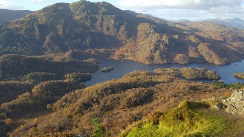 Scenic view of lake and mountains against sky