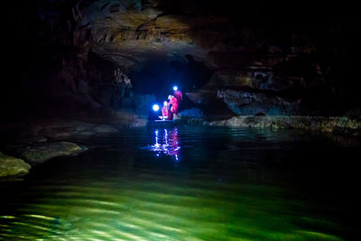 People on rock in cave