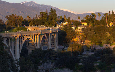 Colorado street bridge at sunset with snow covered mountains in the distance