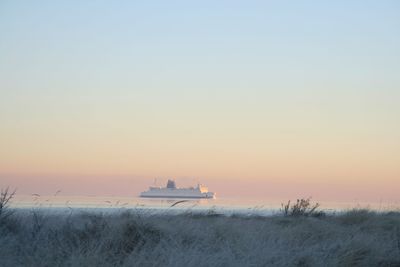 Lone boat in calm sea at sunset