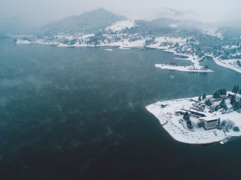 Aerial view of sea and snowcapped mountains