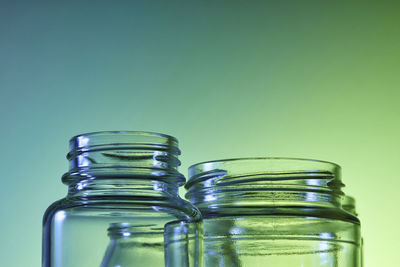 Close-up of green bottles against blue background