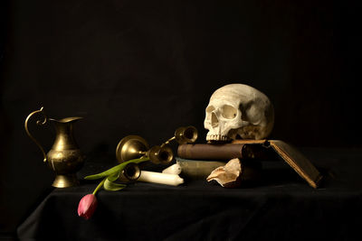 Close-up of statue on table against black background