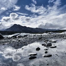 Scenic view of mountains against cloudy sky