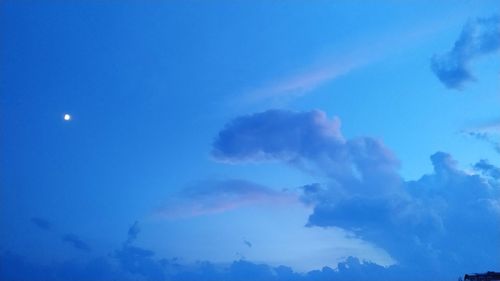 Low angle view of moon in sky at night