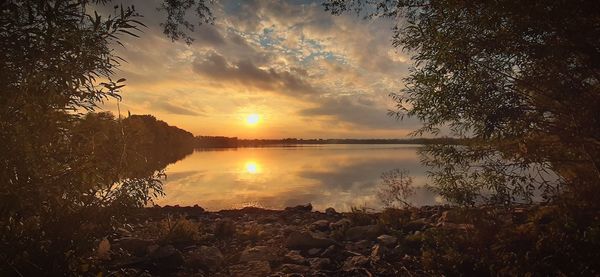 Scenic view of lake against sky during sunset