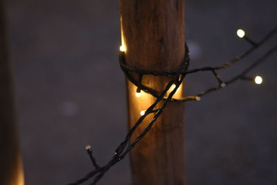 Close-up of illuminated lamp post at night