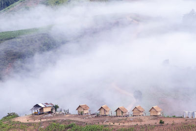 Panoramic view of houses on land against sky