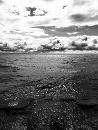 Scenic view of sea against cloudy sky