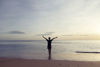 Rear view of person standing on beach