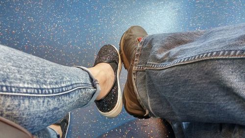 Low section of woman sitting on bench