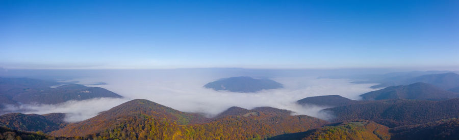 Scenic view of mountain range against cloudy sky