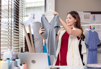 Young woman standing in front of store