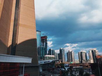 View of skyscrapers against cloudy sky