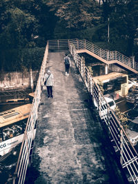 High angle view of people walking on footbridge