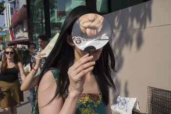 PORTRAIT OF YOUNG WOMAN STANDING ON WALL