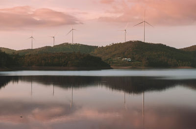 Scenic view of lake against sky at sunset