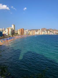 Scenic view of sea and buildings against sky