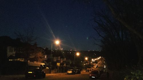 Illuminated city against sky at night