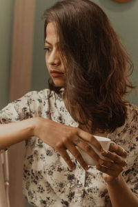 Woman drinking coffee at home