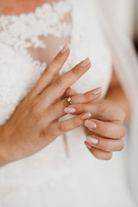 Midsection of bride wearing ring in finger