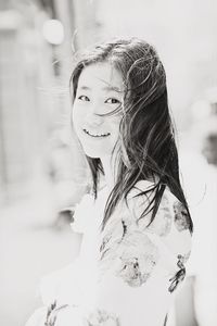 Close-up portrait of smiling young woman