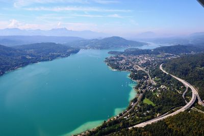 Aerial view of sea and city against sky