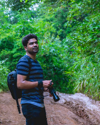 Young man standing in forest