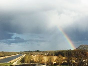 Rainbow over landscape against sky