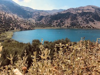 Scenic view of lake and mountains against sky