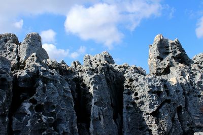 Low angle view of rocks against sky