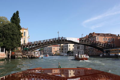 Bridge over river against buildings in city