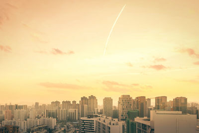 Cityscape against sky during sunset