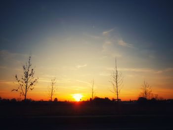 Scenic view of silhouette field against sky during sunset