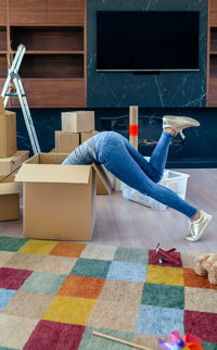 Side view of person lying on floor at home