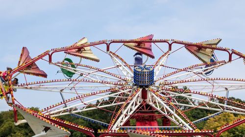 Low angle view of fairground ride against sky.