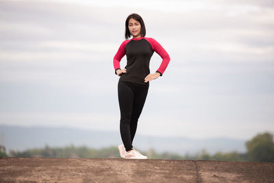 Full length of woman standing against sky