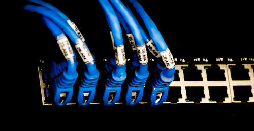 Close-up of illuminated lighting equipment against black background