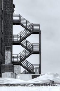 Low angle view of building covered with snow