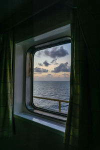 Looking out of window from a cabin of a construction work barge at oil field