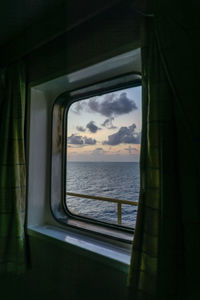 Scenic view of sea seen through train window