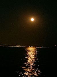 Scenic view of lake against sky at night