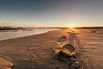 Scenic view of beach against sky during sunset