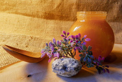 Close-up of fresh purple flowers in glass jar on table