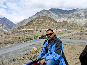 Full length of young man in mountains against sky