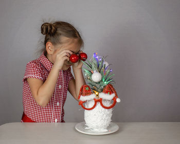 Side view of young woman holding flower