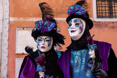 Portrait of young couple standing outdoors