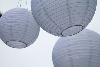 Low angle view of white lanterns against clear sky