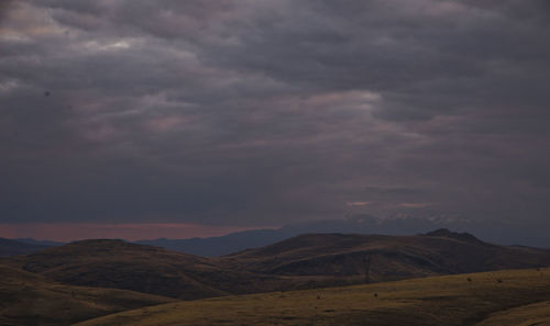 Scenic view of mountains against cloudy sky