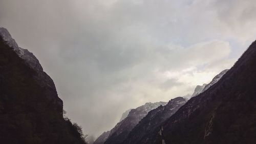 Scenic view of mountains against cloudy sky